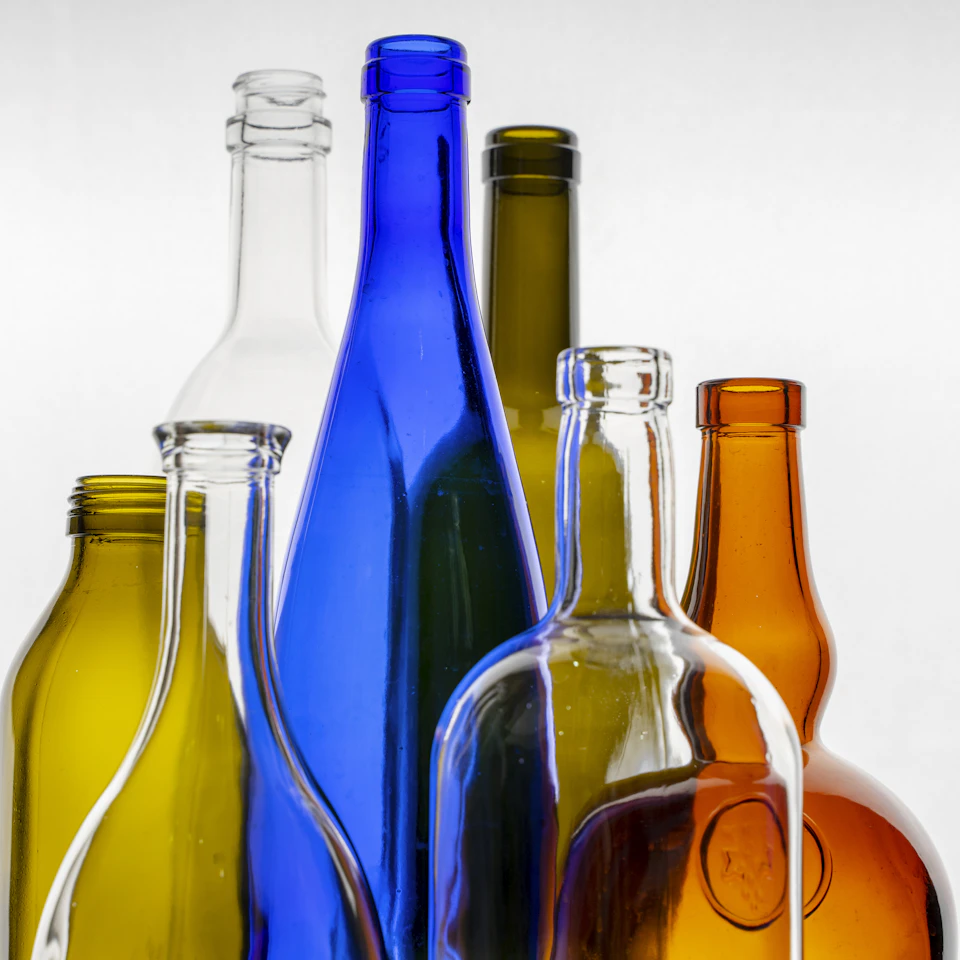 Collection of cosmetic glass bottles in warm light