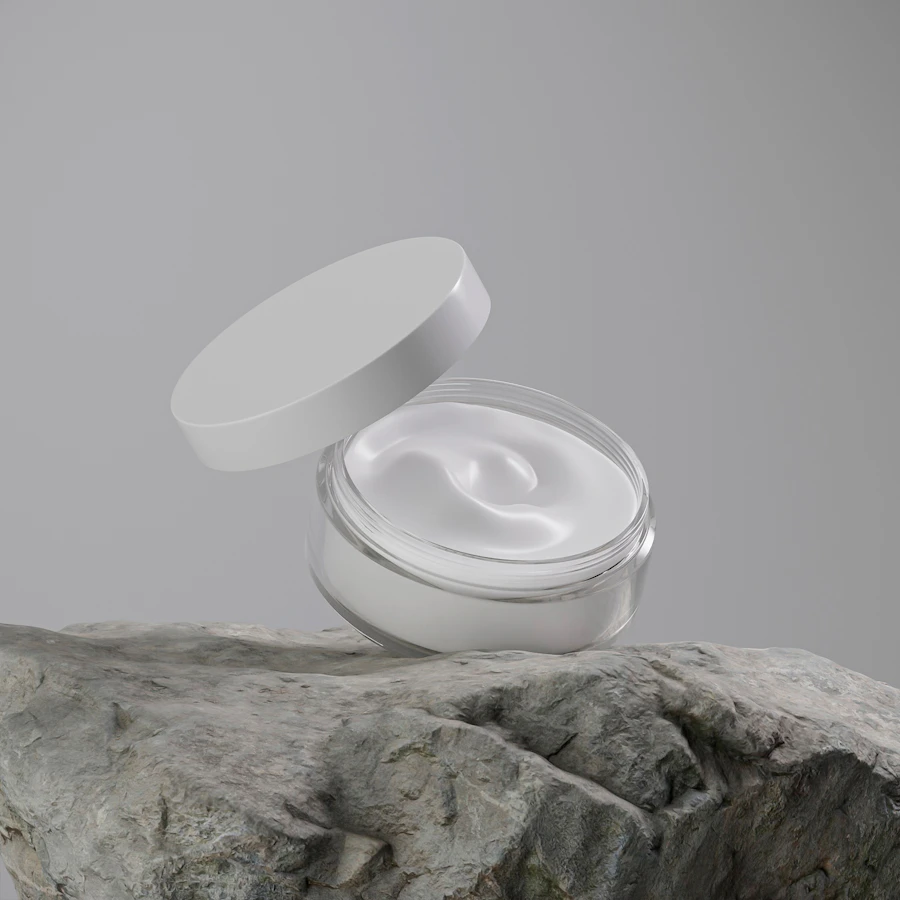 Frosted cream jar with lid on a light surface