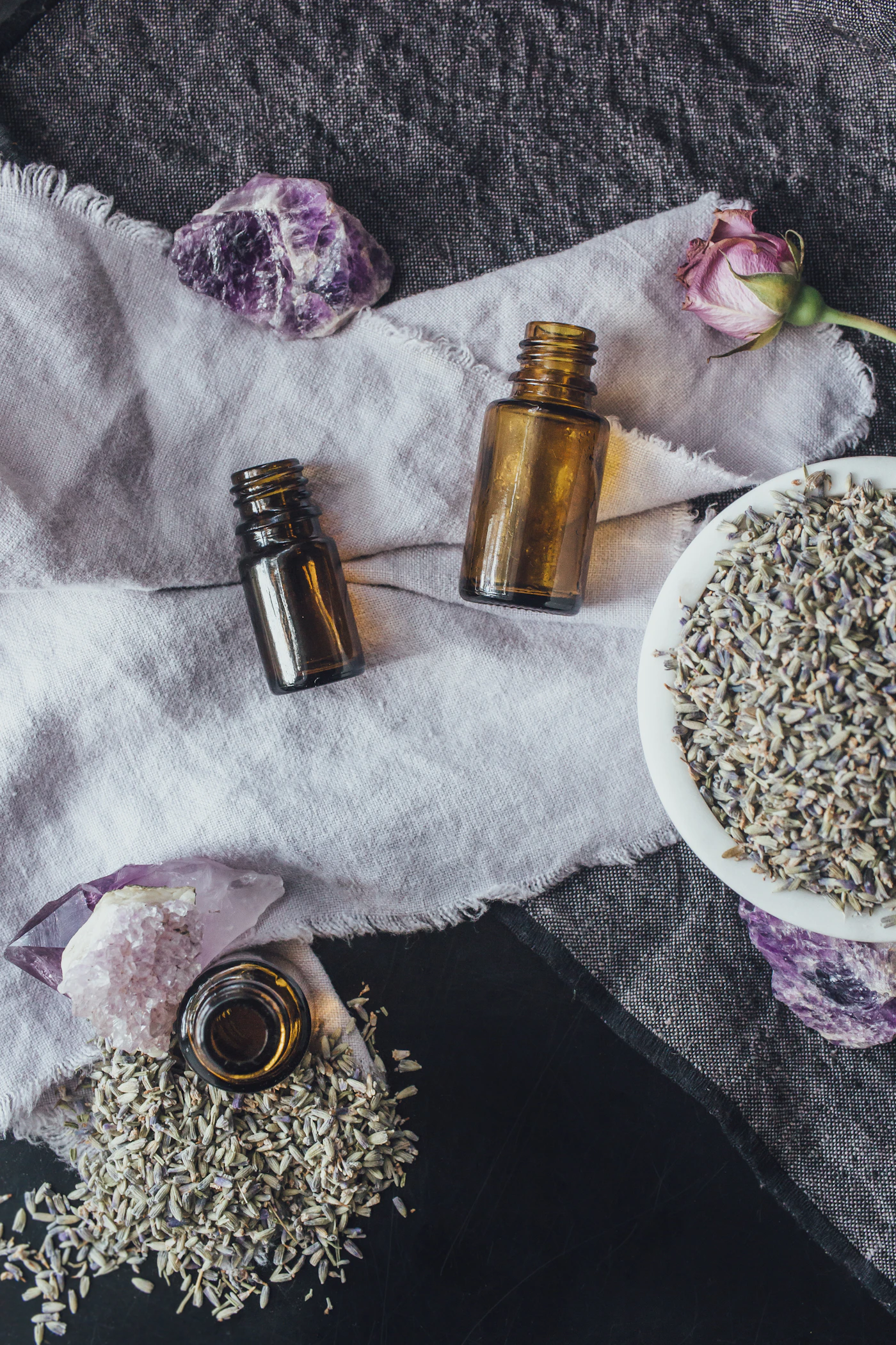 Amber essential oil bottles with dropper caps in soft light